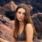 girl sitting on the beach with water